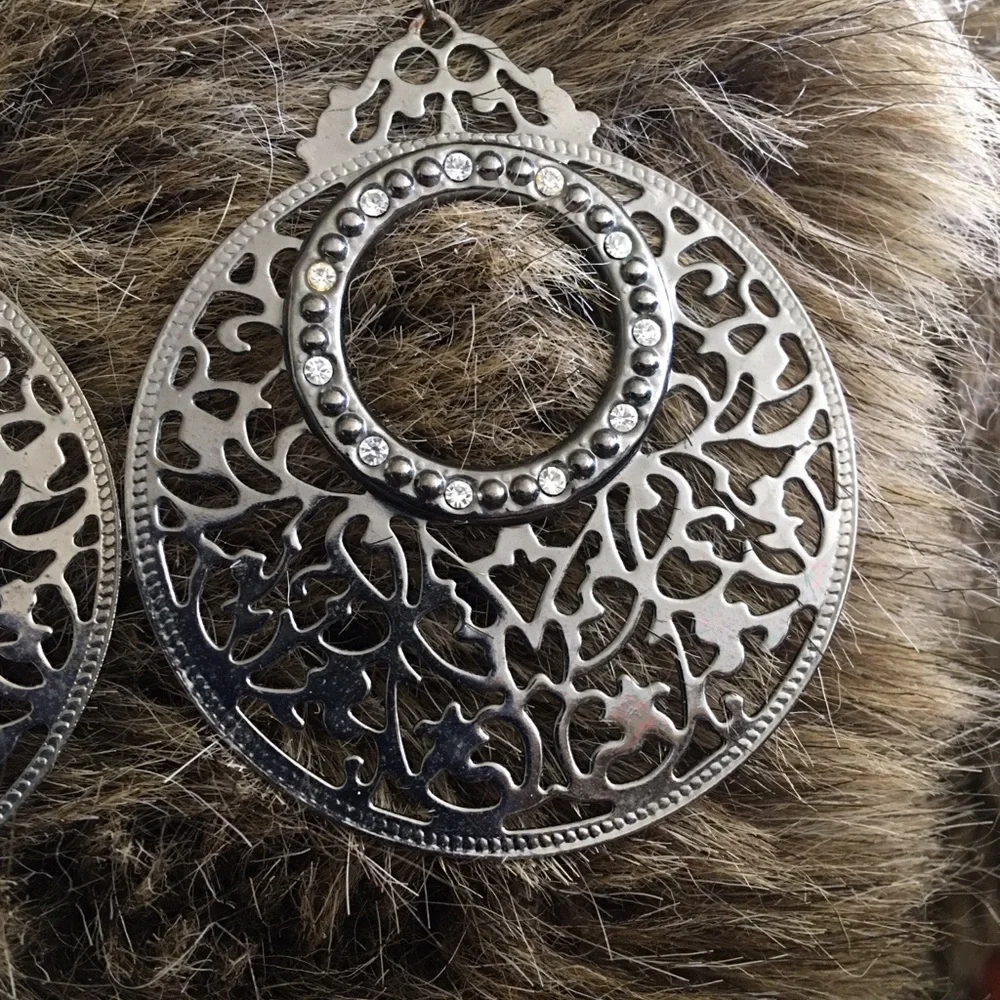 Large chrome tone scroll rhinestone earrings